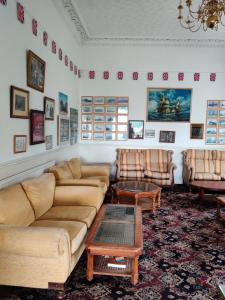 a living room with couches and a coffee table at Inglewood Palm Hotel, Abbey Sands Torquay in Torquay