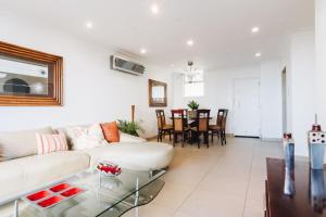 a living room with a white couch and a table at 104 Ipanema Beach in Durban
