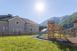 a playground in a yard with a house at NaturparkResort Alte Schule in Hieflau