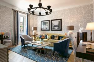 a living room with a couch and a table at Rocco Forte Hotel De Russie in Rome