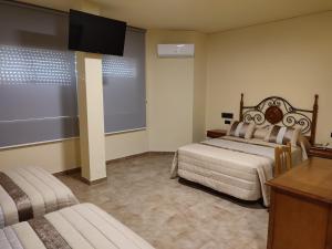 Posteľ alebo postele v izbe v ubytovaní Hotel Novo