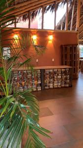 a room with a bench and a bunch of wine barrels at Pousada Vila Camurim in Atins