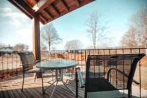 a patio with a table and chairs on a deck at La Trientale 10 pers -Malmedy in Xhoffraix