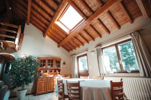 a kitchen with a table and some windows at La Trientale 10 pers -Malmedy in Xhoffraix