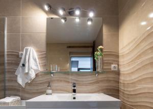 a bathroom with a sink and a mirror at Central Park Home Spa in Arandjelovac +50 photos