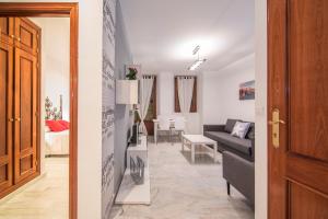 a living room with a couch and a table at Apartamentos Granata in Granada