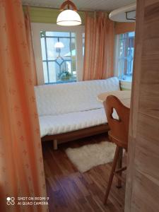 a white bench in a room with a window at Jurmala`s Center Mini House in Jūrmala