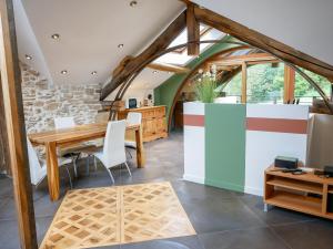 a dining room with a wooden table and chairs at Gîte de l'Arche in Panossas +5 photos