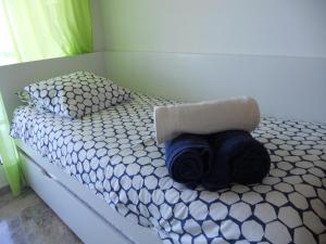 a bed with a towel on top of it at Apartamento Azul Marino by Rental Olé in San Blas