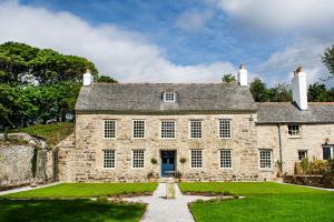 an old stone house with a blue door at Cusgarne Manor boutique B&B - adults only 