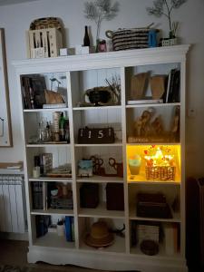 a white book shelf filled with lots of items at City EPI-CENTER in San Sebastián