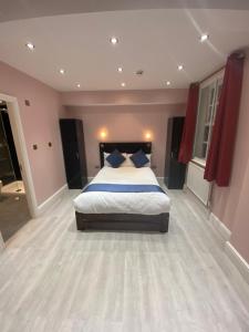 a bedroom with a large bed and a large window at Ville Hotel in Manchester