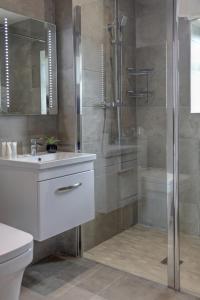 a bathroom with a shower and a toilet and a sink at Kinloch Hotel, Isle of Arran in Blackwaterfoot
