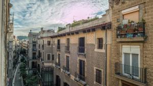a row of brick buildings on a city street at Cathedral Apartments in Barcelona