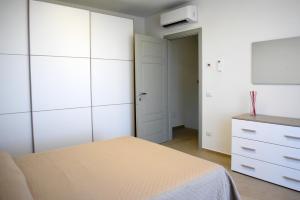 a bedroom with white cabinets and a bed and a dresser at Villa al Mare in Bellaria-Igea Marina +5 photos