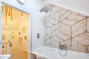 a bathroom with a shower and a marble wall at Luxury lodge in the heart of the Cotswolds in Cirencester