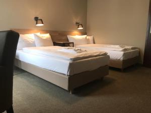 Postel nebo postele na pokoji v ubytování Comm Hotel Poznań Airport