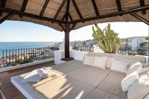 a patio with a couch and a view of the ocean at TESS Penthouse Deluxe DS11 in Torremolinos