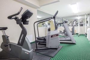 a gym with two treadmills and a treadmill at Ramada by Wyndham Angola/Fremont Area in Angola