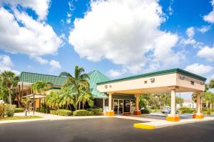 a gas station with palm trees in front of it at Super 8 by Wyndham North Palm Beach in North Palm Beach