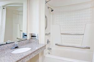 a bathroom with a sink and a shower at Super 8 by Wyndham Suwanee in Suwanee