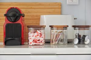 a kitchen counter with a red mixer and jars of food at Deluxe Apt at Amazing Prime Location, By TimeCooler in Lisbon
