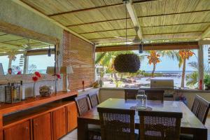 a restaurant with a table and a view of the beach at White Oaks Villas in Trou aux Biches