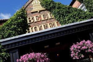 a sign for a bell hotel with pink flowers at Best Western Bell in Driffield in Great Driffield