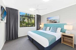 A bed or beds in a room at Club Wyndham Flynns Beach, Trademark Collection by Wyndham