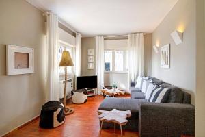 a living room with a couch and a tv at Villa Apple in Vale do Lobo