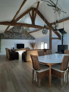 a living room with a table and chairs at Au Cœur des Vallées in Couvin