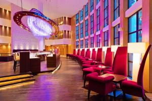 a restaurant with red chairs and a bar at Radisson Blu Resort Bukovel in Bukovel