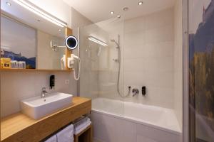 a bathroom with a sink and a shower and a tub at Hotel Donauhof in Emmersdorf an der Donau