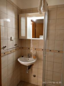 a bathroom with a sink and a mirror at Apartmani Steni in Sveti Stefan +66 photos