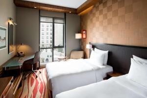 A bed or beds in a room at Radisson Blu Hotel, Dubai Media City