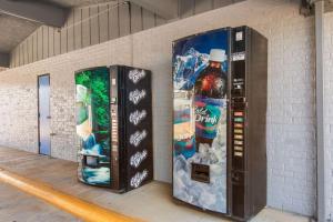 two vending machines sitting next to a brick wall at Rodeway Inn in Nashville