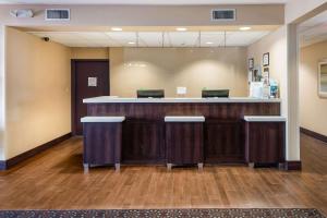 a lobby with a bar with two laptops on it at Quality Inn & Suites Quincy - Downtown in Quincy