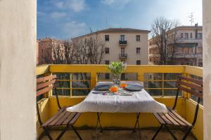 a table and two chairs on a balcony at Saffi Huge Apartment a pochi passi dall'Ospedale in Bologna