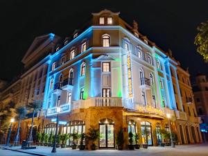 a building lit up in blue and white at Ngọc Ánh Dương Hotel in Ha Long