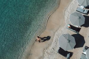 an overhead view of a person on the beach at Mykonos Ammos Hotel - Small Luxury Hotels of the World in Ornos