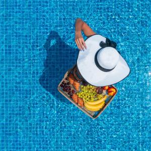 a tray of fruit and vegetables in a swimming pool at Nerea SeaFront Villa, a Pristine Retreat, By ThinkVilla in Akrotiri +44 photos