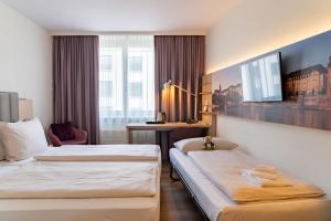 Essential by Dorint Basel City客房内的一张或多张床位