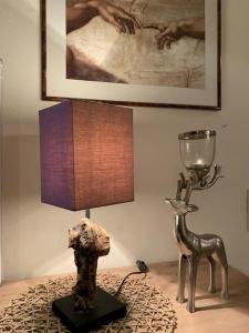 a statue of a dog and a lamp on a table at Bergschlössl Fewo 28 in Oberaudorf