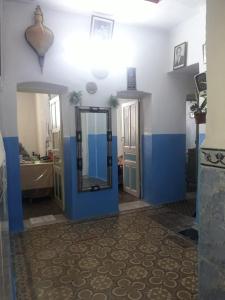 a bathroom with blue and white walls and a mirror at Hôtel Glacier in Fez