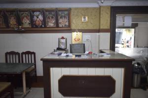a kitchen with a counter with a laptop on it at Sri Krishna Vilas in Coimbatore