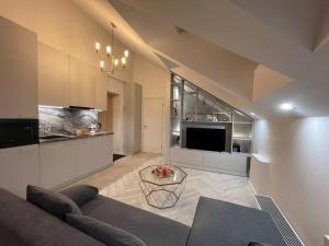 a living room with a couch and a table at E.M. Studio In City Center in Kaunas