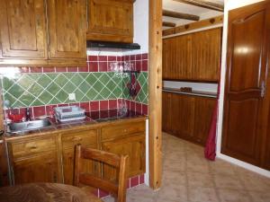 a kitchen with wooden cabinets and a sink at GAUDISSARD A619 in Barcelonnette