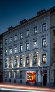 un gran edificio blanco con luces en las ventanas en Hotel Lucia, en Viena