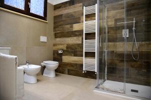 a bathroom with a toilet and a glass shower at Dea Igea Apartment in Bellaria-Igea Marina +1 photo