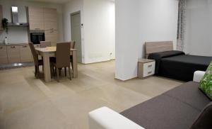 a living room with a couch and a table at Dea Igea Apartment in Bellaria-Igea Marina